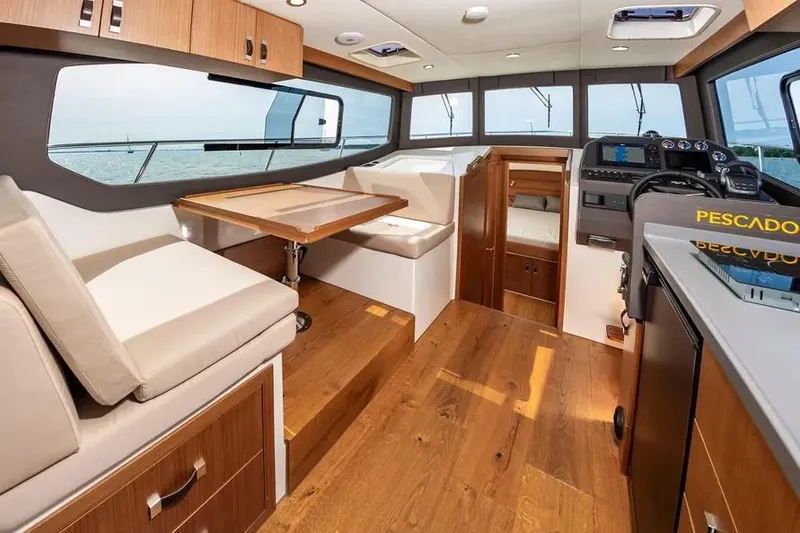 Slide: The Image of Luxurious interior of 2023 Pescador 35 boat with wood flooring and modern amenities. - 17