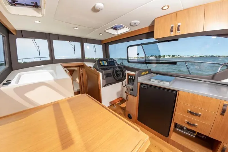 Slide: The Image of Interior of 2023 Pescador 35 boat with modern helm and kitchen area. - 19
