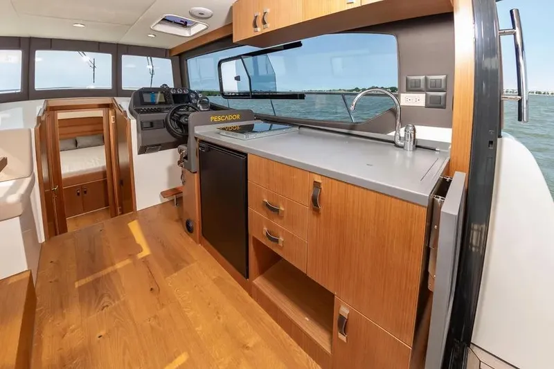 Slide: The Image of 2023 Pescador 35 boat interior with modern kitchen and steering area. - 20