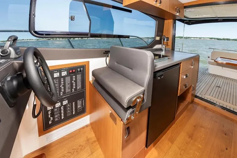 Slide: The Image of Interior of 2023 Pescador 35 boat with helm, kitchen, and seating area. - 23