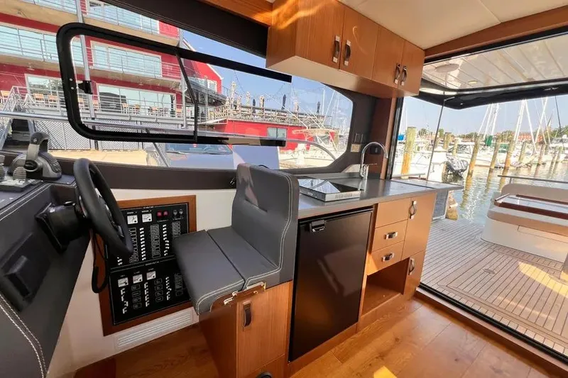 Slide: The Image of Interior of 2023 Pescador 35 boat with modern helm and kitchenette. - 25