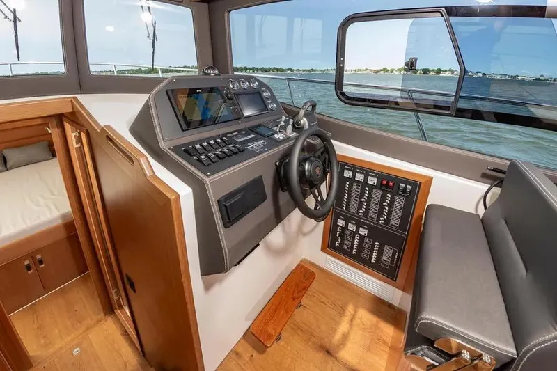 Slide: The Image of Interior of 2023 Pescador 35 boat, featuring modern helm and control panel. - 27