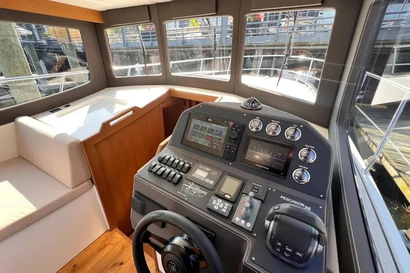 Slide: The Image of Interior view of 2023 Pescador 35 boat cockpit with modern navigation controls. - 28