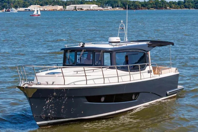 Slide: The Image of 2023 Pescador 35 boat cruising on a sunny day in open water. - 3