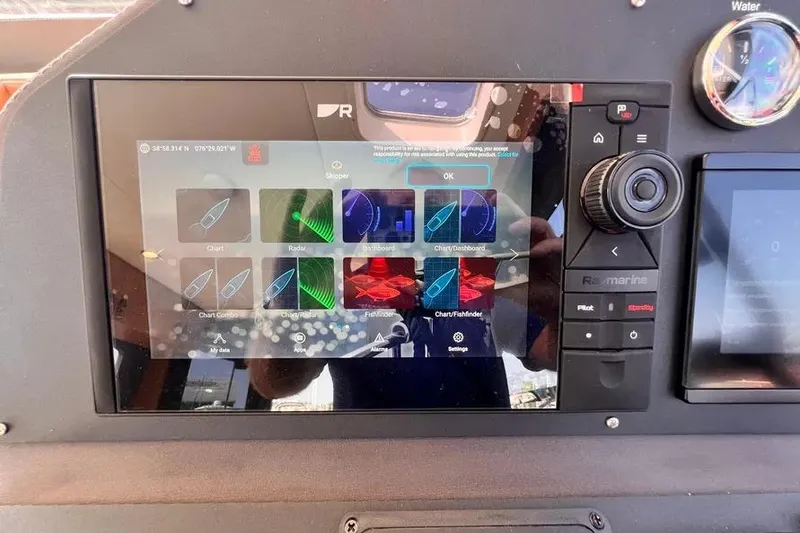 Slide: The Image of Touchscreen navigation system on 2023 Pescador 35 boat dashboard, displaying various marine applications. - 30