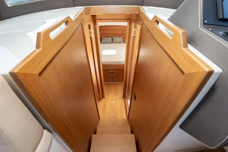 Slide: The Image of Interior view of 2023 Pescador 35 yacht cabin with wooden stairs and cozy bedroom. - 33