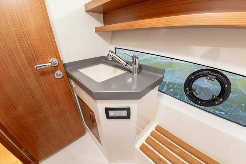 Slide: The Image of Modern bathroom interior on 2023 Pescador 35 boat with sink and porthole view. - 34