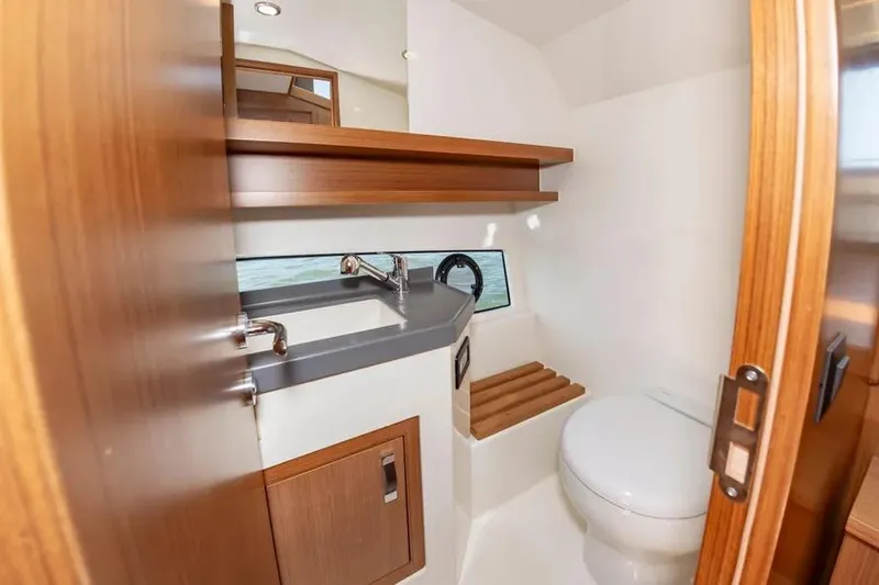 Slide: The Image of Modern bathroom interior on 2023 Pescador 35 boat, featuring sink and toilet. - 35