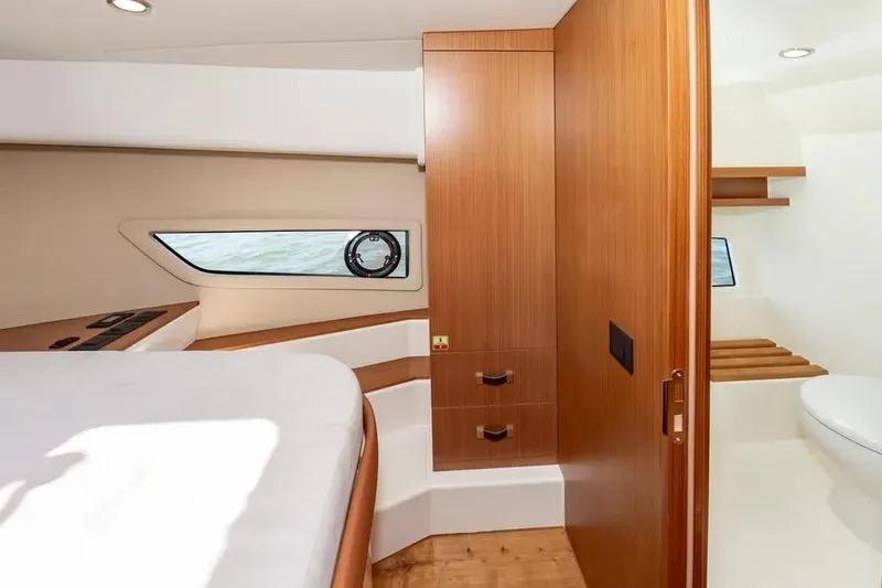 Slide: The Image of Interior of 2023 Pescador 35 boat featuring wood cabinetry and modern design elements. - 36