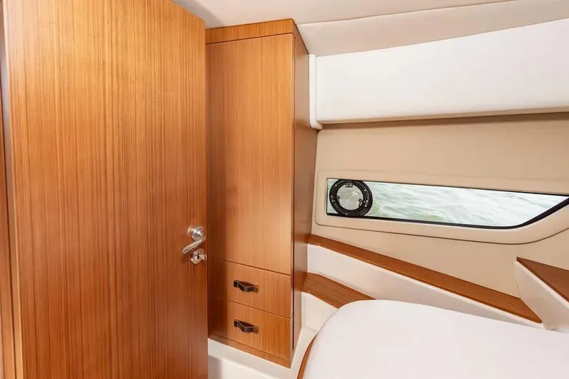 Slide: The Image of Interior of 2023 Pescador 35 yacht with wooden cabinetry and porthole window. - 37