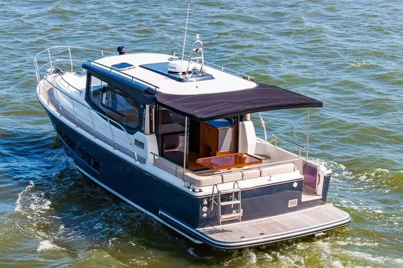 Slide: The Image of 2023 Pescador 35 boat cruising on open water, featuring sleek design and spacious deck. - 4