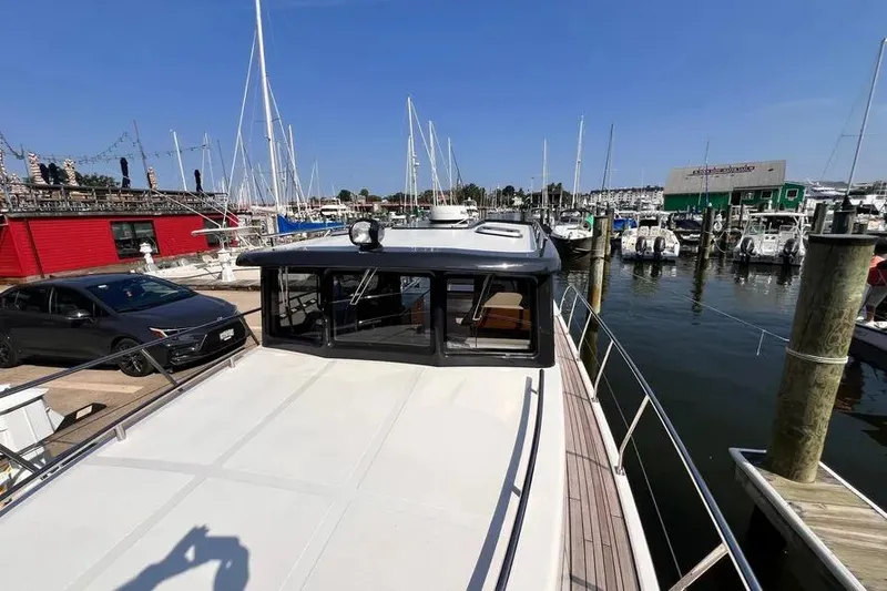 Slide: The Image of 2023 Pescador 35 boat docked at a marina with clear blue skies. - 43