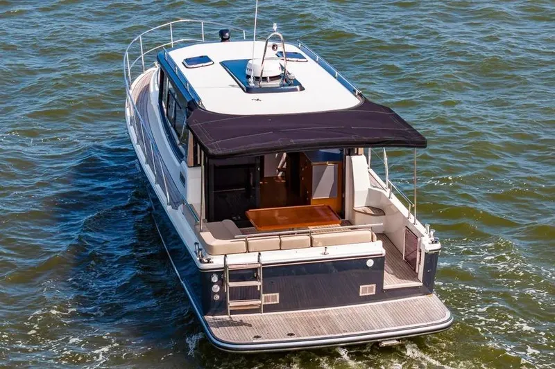 Slide: The Image of 2023 Pescador 35 boat cruising on open water, featuring a sleek design and spacious deck. - 6