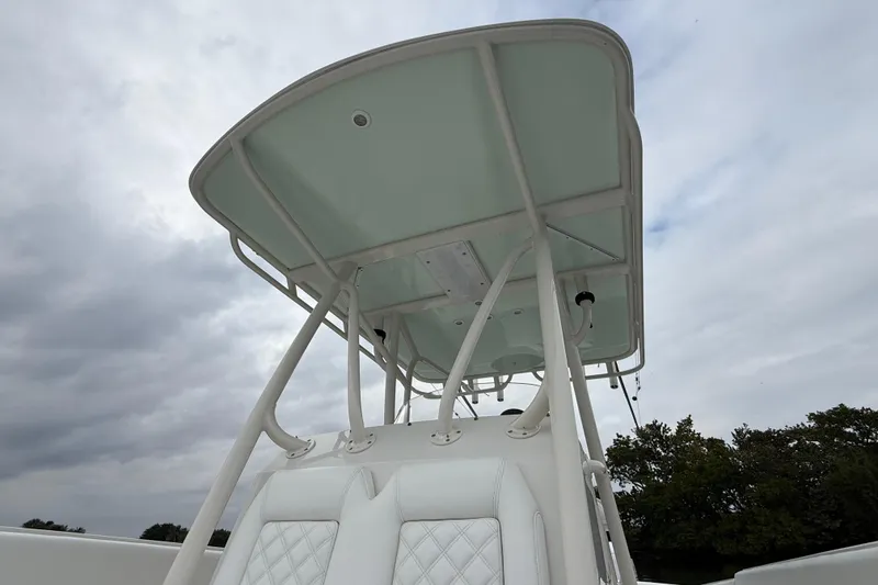 Slide: The Image of T-top of a 2009 Jupiter 29 boat against a cloudy sky background. - 12