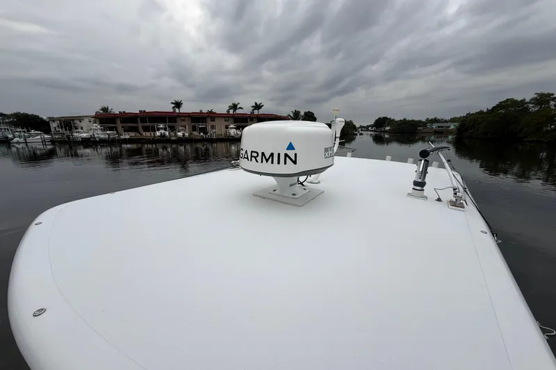 Slide: The Image of 2009 Jupiter 29 boat with Garmin radar on deck, overcast sky, waterfront view. - 18