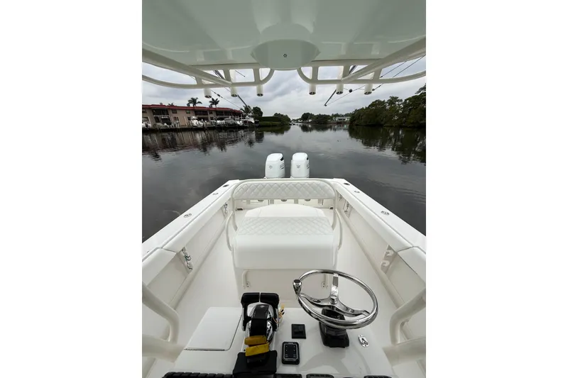 Slide: The Image of 2009 Jupiter 29 boat interior with steering wheel, calm water view. - 21