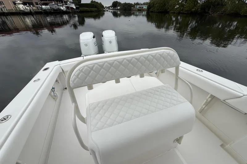 Slide: The Image of 2009 Jupiter 29 boat with dual engines and quilted seating on calm water. - 23