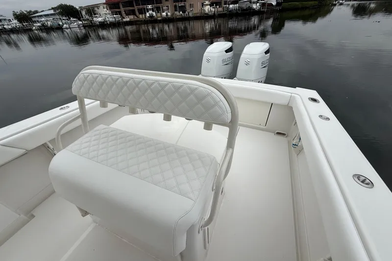 Slide: The Image of 2009 Jupiter 29 boat with white seating and dual Suzuki outboard motors. - 24