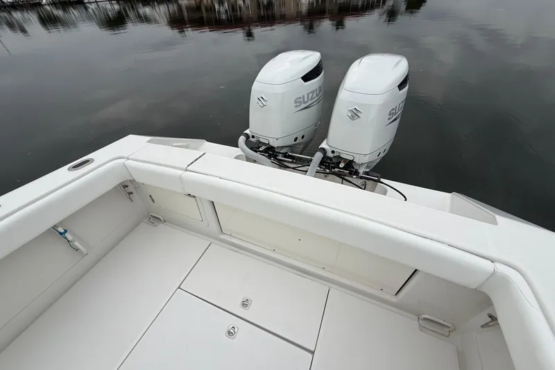 Slide: The Image of 2009 Jupiter 29 boat with twin Suzuki outboard engines on calm water. - 28