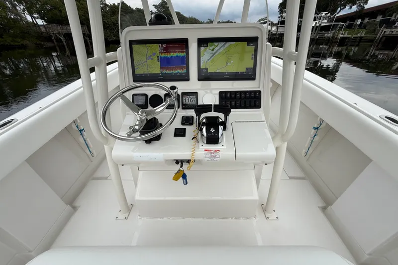 Slide: The Image of 2009 Jupiter 29 boat console with navigation screens and steering wheel. - 36