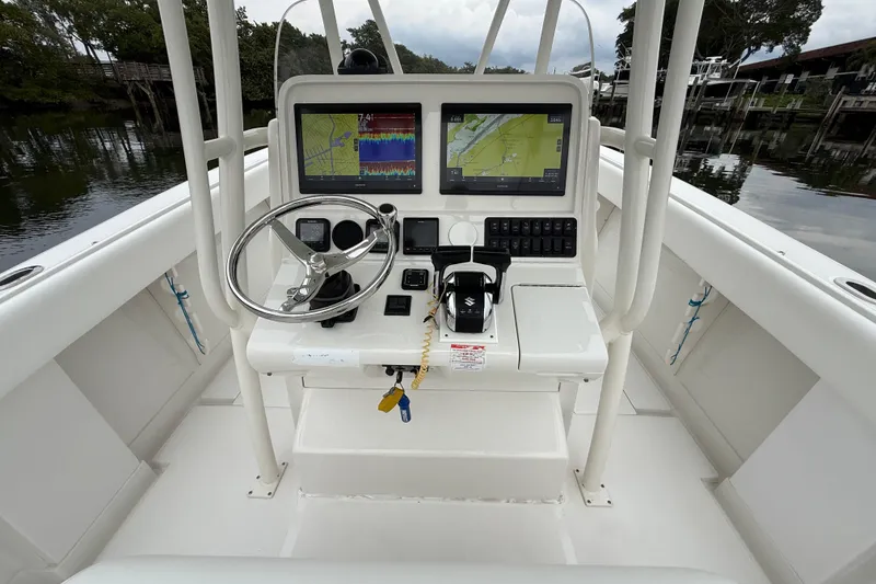 Slide: The Image of Steering console of 2009 Jupiter 29 boat with navigation screens and controls. - 37