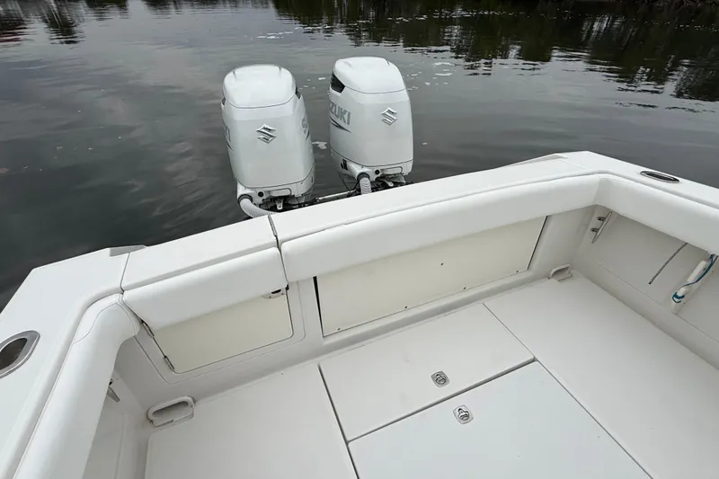 Slide: The Image of 2009 Jupiter 29 boat with dual Suzuki outboard engines on calm water. - 7