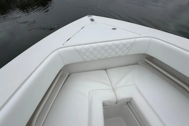 Slide: The Image of Bow seating area of a 2009 Jupiter 29 boat with white upholstery. - 8