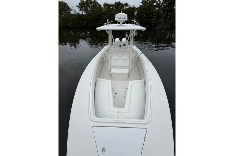 Slide: The Image of 2009 Jupiter 29 boat with white interior, Garmin equipment, docked on calm water. - 9