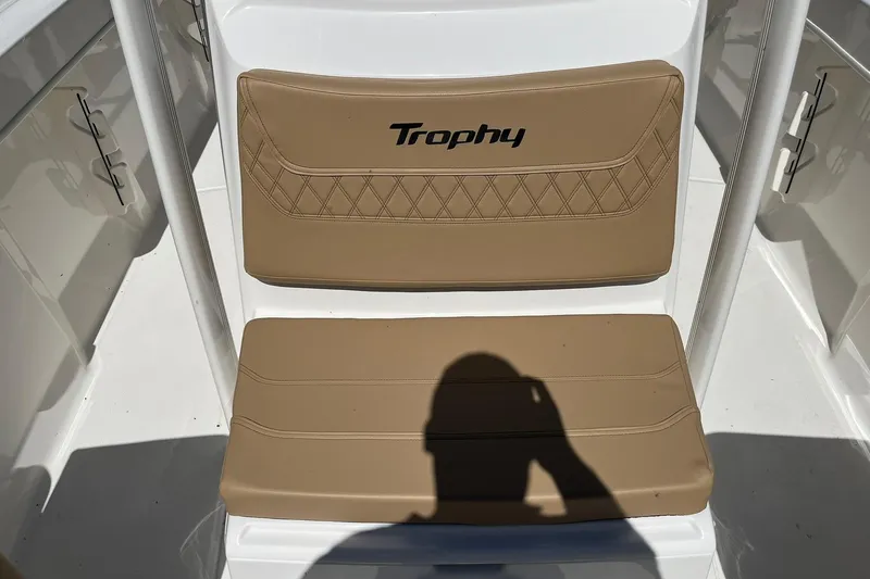 Slide: The Image of 2026 Bayliner Trophy T22CC boat seat with tan upholstery and "Trophy" logo. - 11