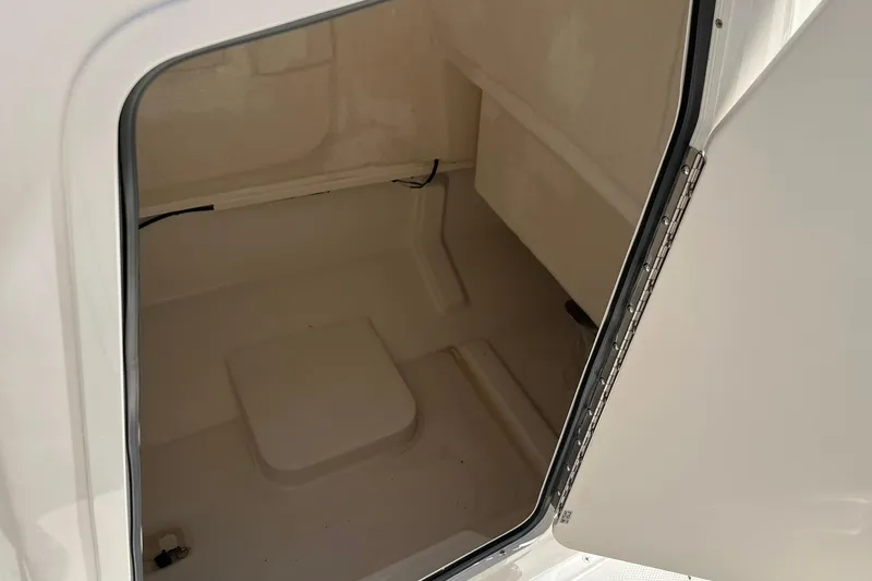 Slide: The Image of Storage compartment of 2026 Bayliner Trophy T22CC boat, open door view. - 12