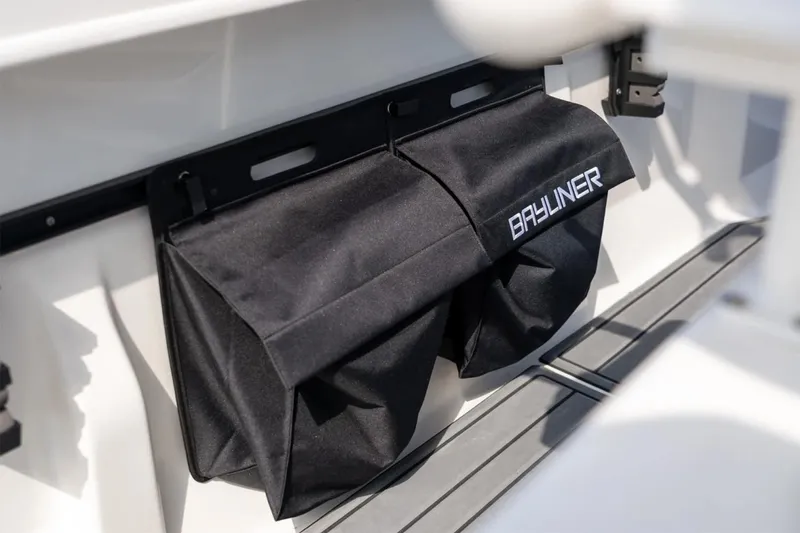 Slide: The Image of Manufacturer Provided Image: 2025 Bayliner Trophy T22CC storage compartment with branded black cover. - 9