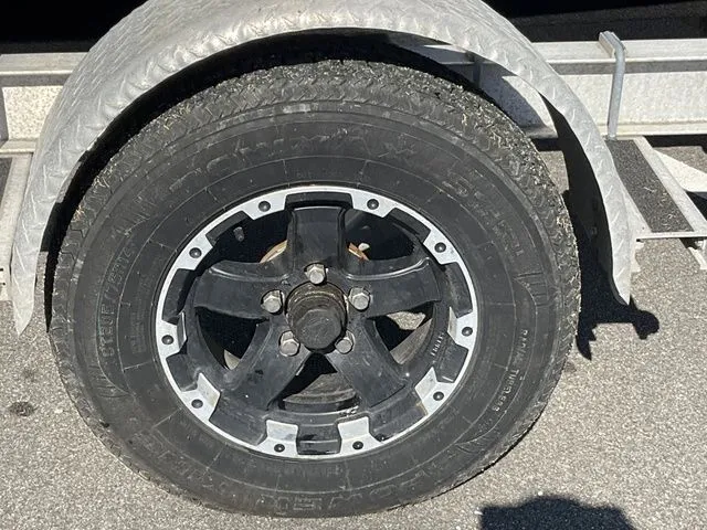 Slide: The Image of Close-up of a tire on a Sportsman 19 Island Reef trailer. - 16