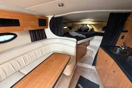 Slide: The Image of Interior of 2004 Regal Commodore 3260 yacht with seating and sleeping area. - 5