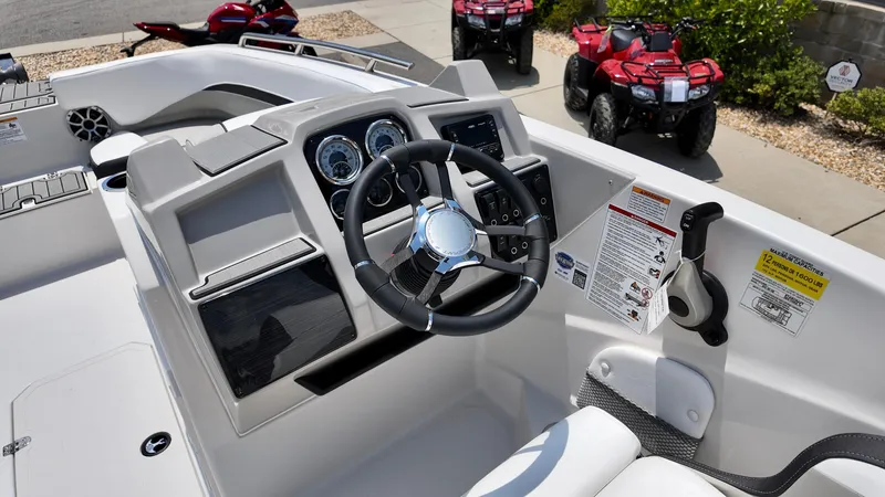 Slide: The Image of 2026 Starcraft SVX 191 OB boat dashboard with steering wheel and control panel. - 10