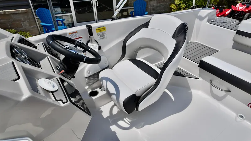 Slide: The Image of 2026 Starcraft SVX 191 OB boat interior with steering wheel and captain's chair. - 11