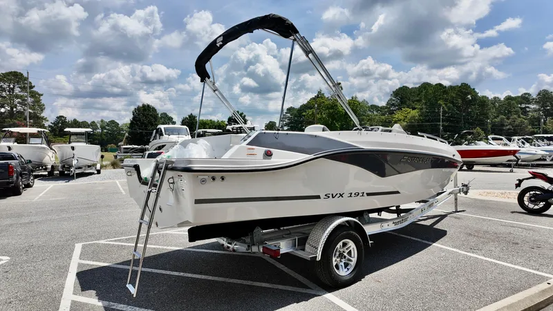 Slide: The Image of 2026 Starcraft SVX 191 OB boat on trailer in parking lot under cloudy sky. - 5