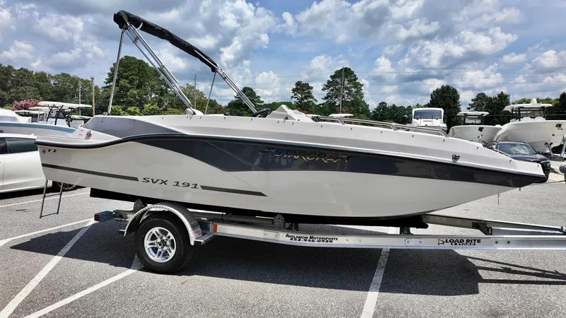Slide: The Image of 2026 Starcraft SVX 191 OB boat on trailer, parked outdoors under a cloudy sky. - 8
