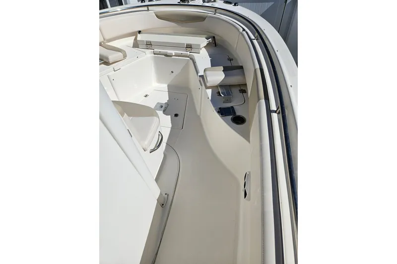 Slide: The Image of 2017 Robalo R242 Center Console boat interior, featuring seating and storage compartments. - 19