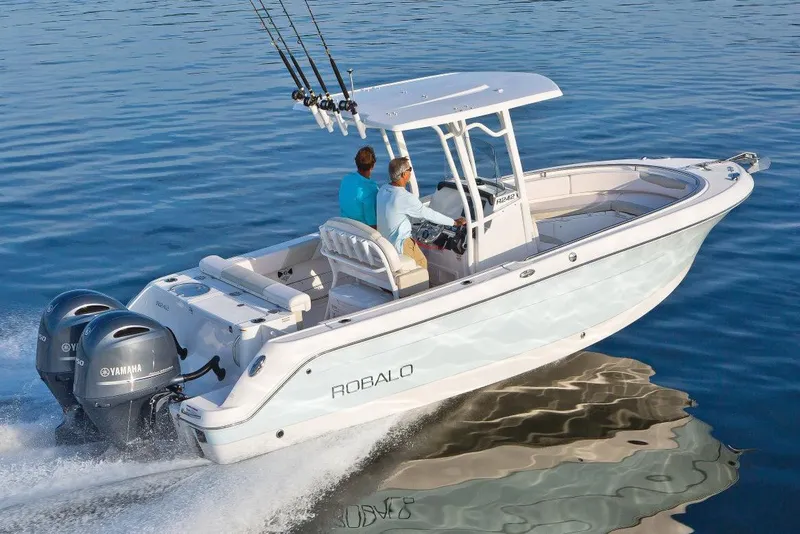 Slide: The Image of Manufacturer Provided Image: 2017 Robalo R242 Center Console boat cruising on water with dual Yamaha engines. - 2