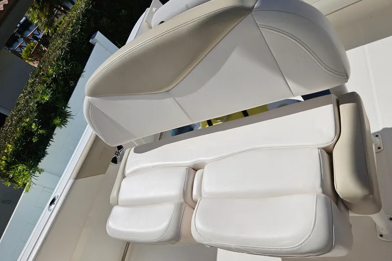 Slide: The Image of 2017 Robalo R242 Center Console boat seat with white upholstery. - 25