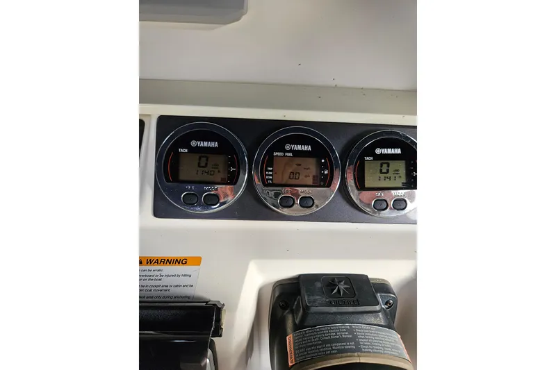 Slide: The Image of Yamaha gauges on 2017 Robalo R242 Center Console boat dashboard. - 27