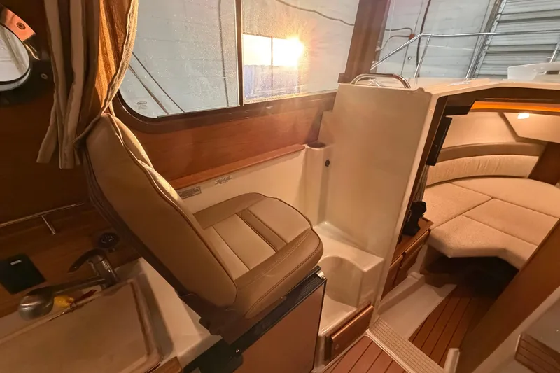Slide: The Image of 2023 Ranger Tugs R-27 interior with seating and cozy cabin area. - 11