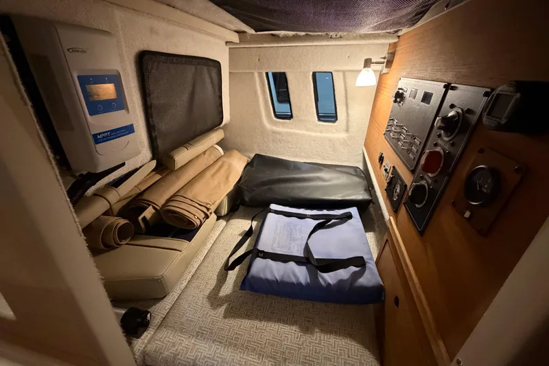 Slide: The Image of 2023 Ranger Tugs R-27 interior cabin with control panel and storage area. - 14