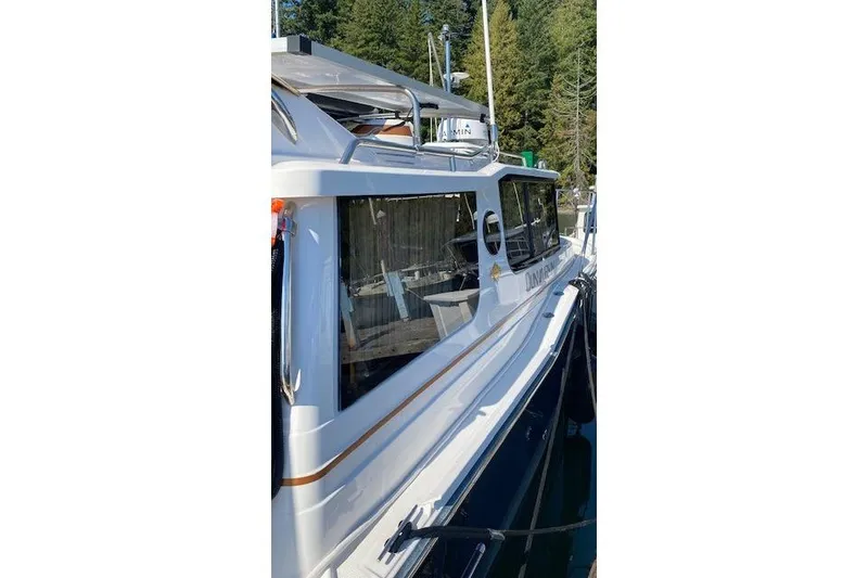 Slide: The Image of 2023 Ranger Tugs R-27 boat docked, showcasing sleek design and modern features. - 3