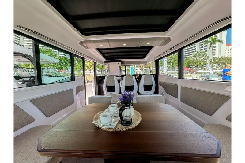 Slide: The Image of 2024 Axopar 45 XC Cross Cabin interior with elegant seating and dining area. - 17