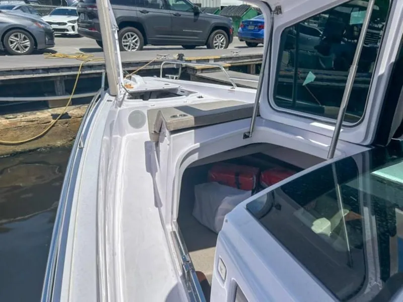 Slide: The Image of 2024 Axopar 45 XC Cross Cabin boat docked, showcasing sleek design and spacious deck. - 32