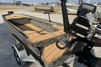 Slide: The Image of 2026 Gator Tail 1854 Extreme boat with camo design on a trailer. - 6