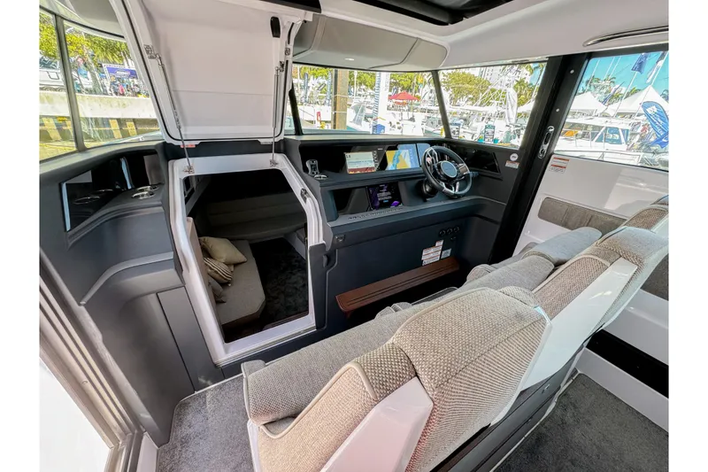 Slide: The Image of 2024 Axopar 45 XC Cross Cabin interior with modern helm and seating. - 20