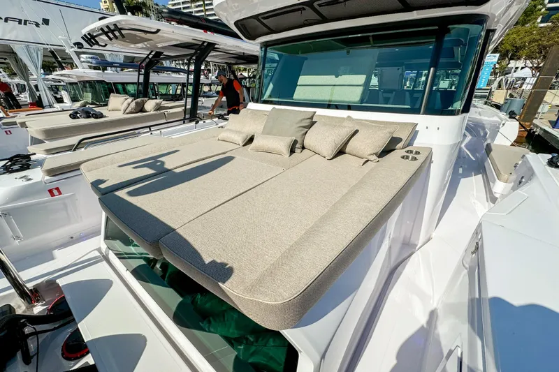 Slide: The Image of 2024 Axopar 45 XC Cross Cabin with sunbathing deck and cushions, docked at marina. - 6