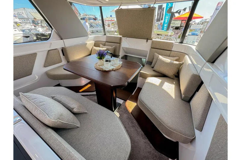 Slide: The Image of Luxurious interior of 2024 Axopar 45 XC Cross Cabin with plush seating and elegant table. - 11